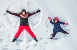 family making snow angels